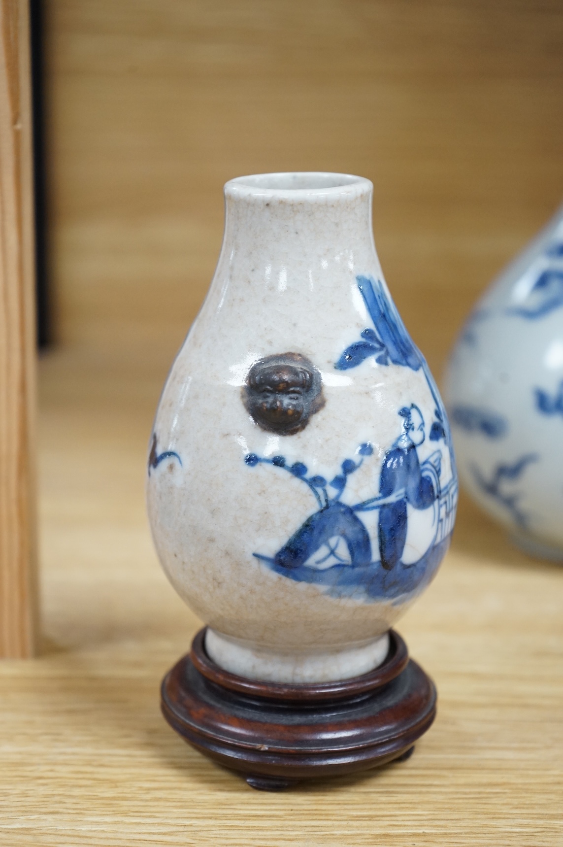 A Chinese blue and white bottle vase, a crackle glaze vase and a Tibetan copper and brass ‘monk’ cap’ ewer (3), tallest 21cm
